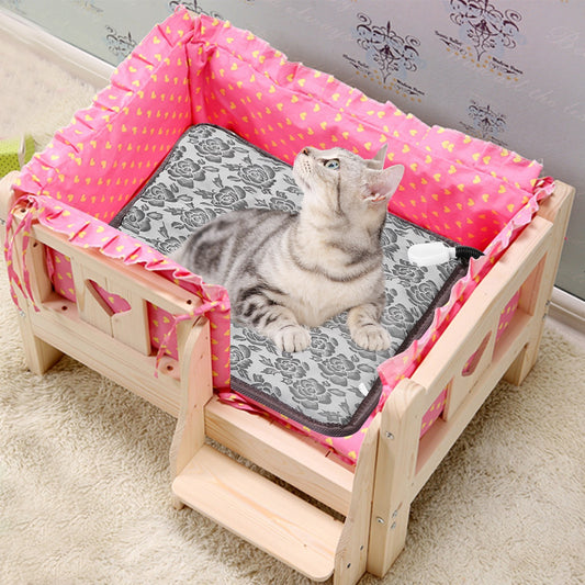 Senior cat resting on electric heating pad in a cozy bed