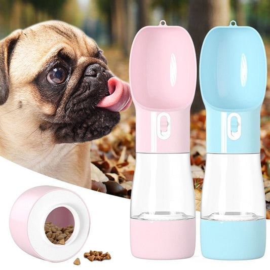 Senior dog drinking from portable water & food travel bottle (258 ml + 200 g) in pink and blue
